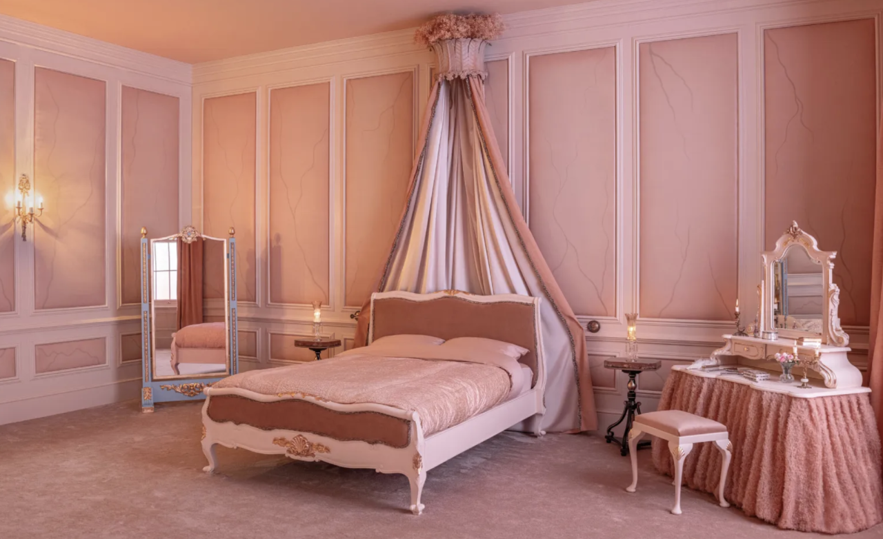 Cathy’s bedroom recreated for the Wuthering Heights Airbnb experience, featuring blush pink walls, a vintage canopy bed, and romantic candlelit details in Yorkshire.